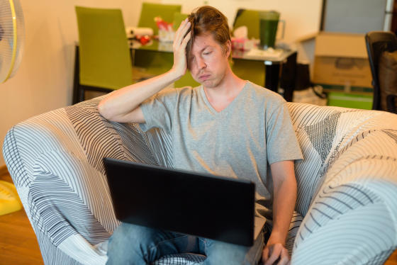 Man on a virtual interview in casual clothes and a messy room